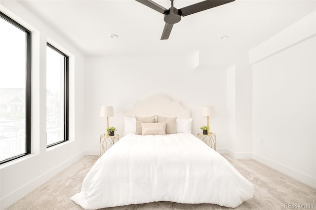 bedroom with light carpet and ceiling fan