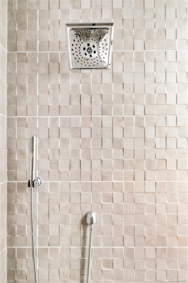 interior details featuring a tile shower