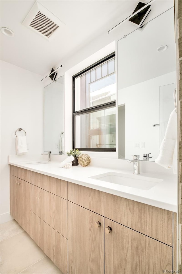 bathroom featuring tile patterned flooring and vanity