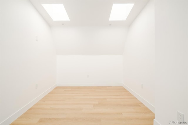 unfurnished room with wood-type flooring and lofted ceiling