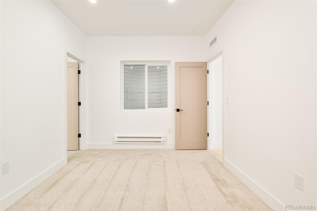 corridor featuring a baseboard radiator and light colored carpet