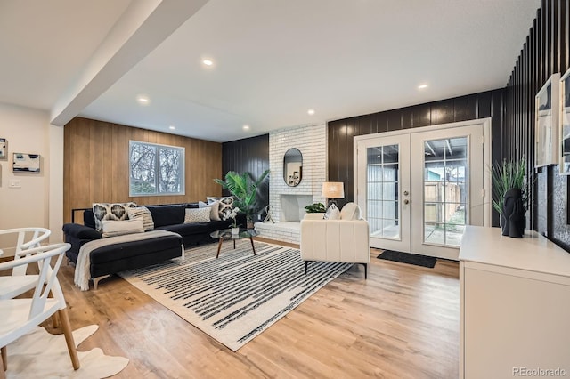 1040 Grove St, Denver, CO 80204 - living area featuring recessed lighting, light wood finished floors, wood walls, and french doors