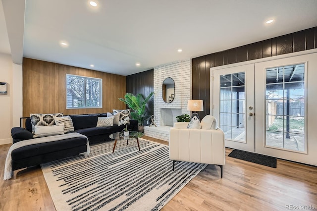 1040 Grove St, Denver, CO 80204 - living room featuring recessed lighting, light wood-style floors, wood walls, and french doors
