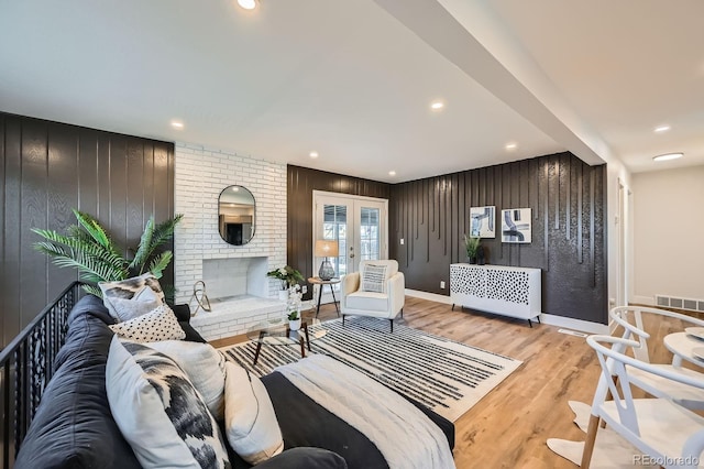 1040 Grove St, Denver, CO 80204 - living area with wooden walls, french doors, light wood-style flooring, baseboards, and recessed lighting