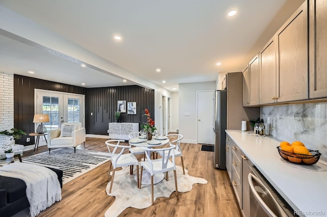 1040 Grove St, Denver, CO 80204 - kitchen with light countertops, light wood-style floors, decorative backsplash, appliances with stainless steel finishes, and open floor plan