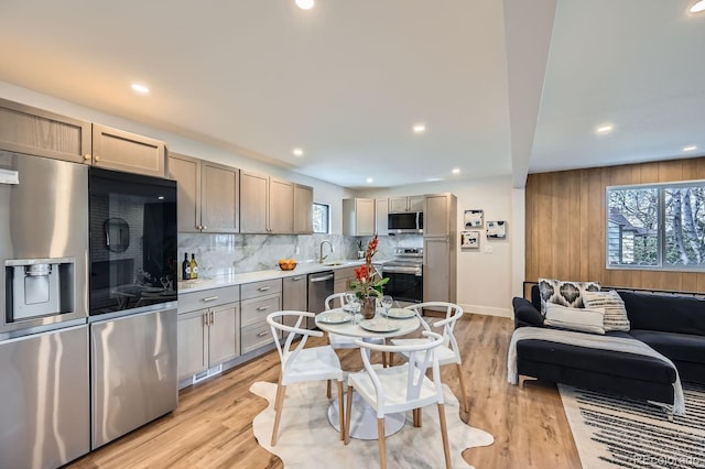 1040 Grove St, Denver, CO 80204 - kitchen with a sink, decorative backsplash, stainless steel appliances, light countertops, and recessed lighting