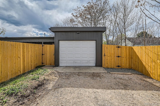 1040 Grove St, Denver, CO 80204 - garage featuring fence, driveway, and a gate