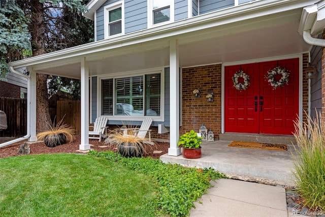 entrance to property featuring a lawn