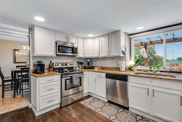 kitchen featuring sink, white cabinets, and appliances with stainless steel finishes