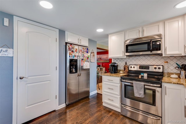 kitchen featuring white cabinetry, appliances with stainless steel finishes, and dark hardwood / wood-style floors