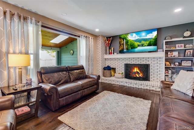 living room featuring a fireplace, vaulted ceiling, dark wood-type flooring, and wood walls