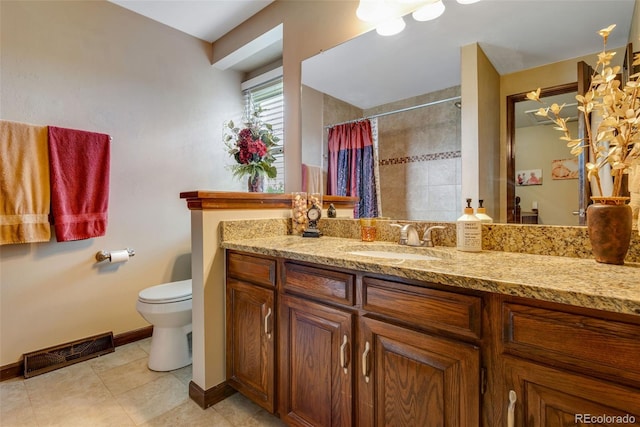 bathroom with toilet, vanity, and walk in shower