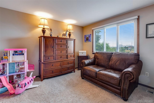 living area with light colored carpet