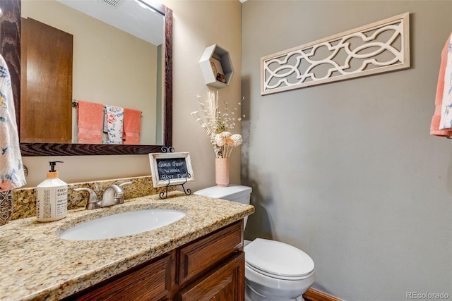 bathroom with toilet and vanity