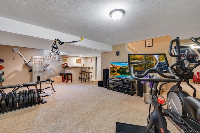 workout room with carpet flooring, bar, and a textured ceiling