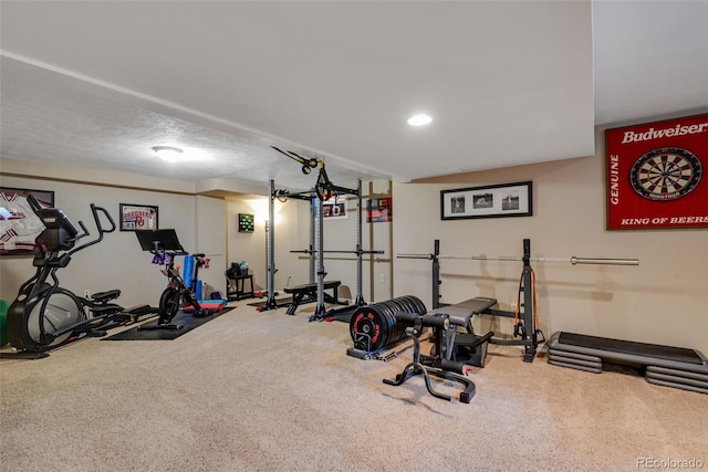 workout room with a textured ceiling and carpet flooring