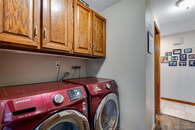 washroom featuring cabinets and washing machine and clothes dryer