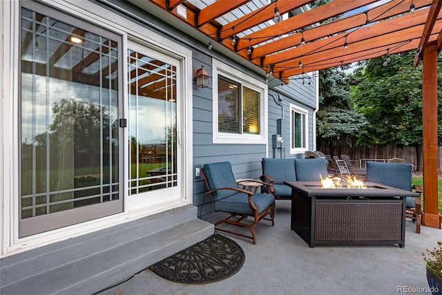 view of patio / terrace with a pergola and an outdoor living space with a fire pit