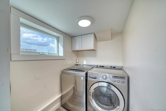 24025 US Highway 285, Buena Vista, CO 81211 - laundry room featuring separate washer and dryer, cabinet space, and a textured wall