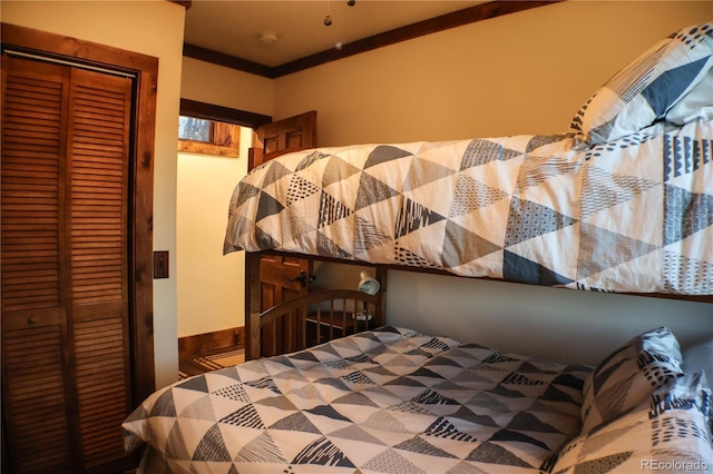 bedroom featuring a closet and ornamental molding