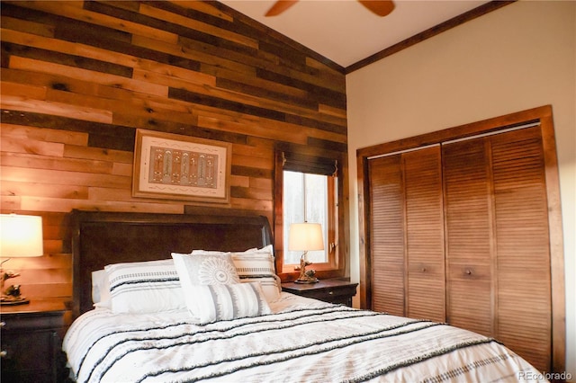 bedroom with ceiling fan, high vaulted ceiling, crown molding, wooden walls, and a closet