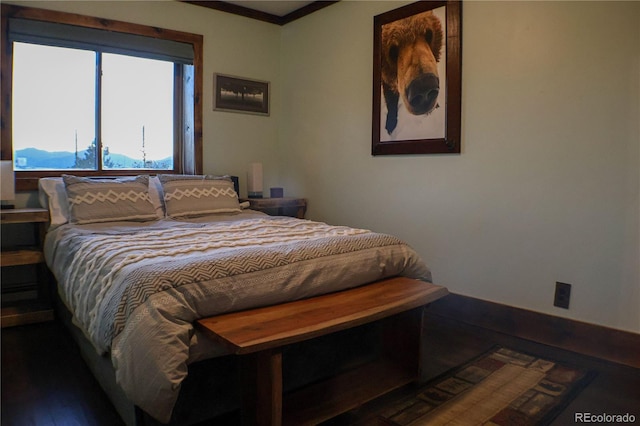 bedroom featuring hardwood / wood-style flooring and crown molding