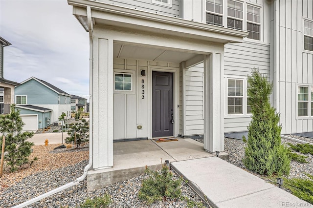 doorway to property with board and batten siding and a porch
