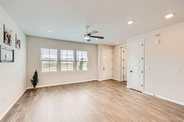 spare room featuring a ceiling fan, baseboards, light wood-style flooring, and recessed lighting