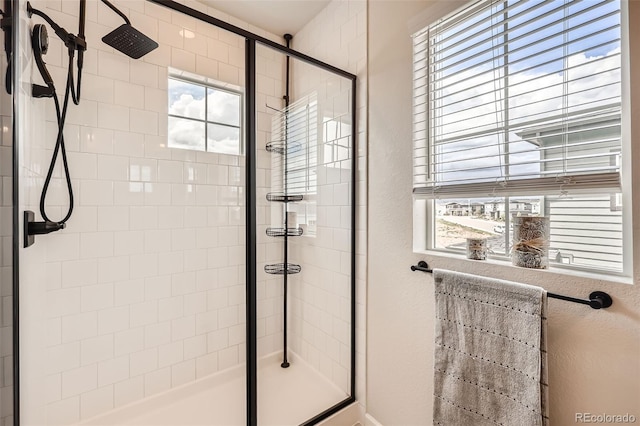 full bath featuring a shower stall and plenty of natural light