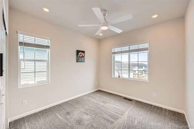 carpeted empty room with baseboards and plenty of natural light