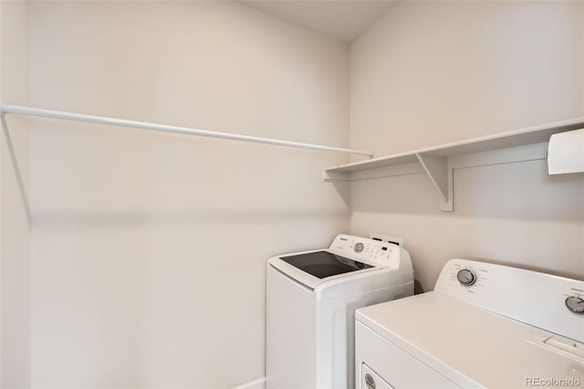 washroom with separate washer and dryer and laundry area