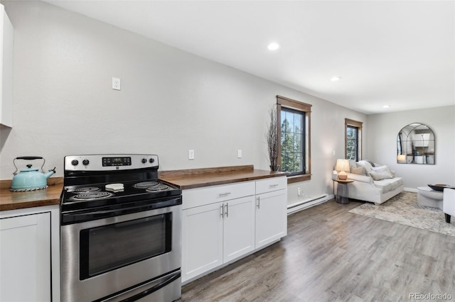 11390 Shimley Rd, Golden, CO 80403 - kitchen featuring butcher block counters, stainless steel range with electric stovetop, baseboard heating, light wood-style flooring, and recessed lighting