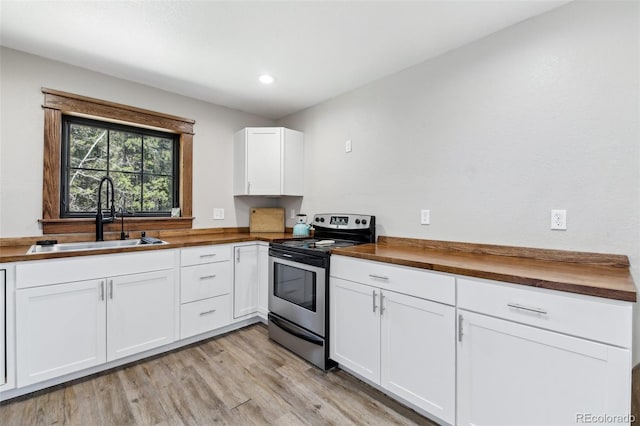 11390 Shimley Rd, Golden, CO 80403 - kitchen with wooden counters, stainless steel electric stove, a sink, white cabinets, and recessed lighting