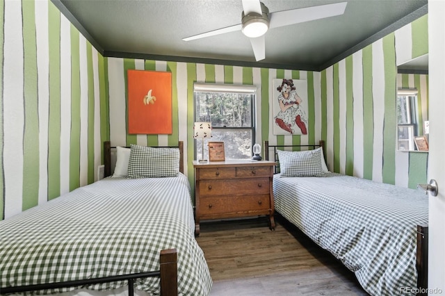 11390 Shimley Rd, Golden, CO 80403 - bedroom with wood finished floors, ceiling fan, and wallpapered walls