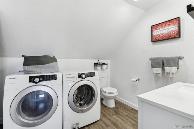 11390 Shimley Rd, Golden, CO 80403 - washroom featuring washer and clothes dryer, light wood-style flooring, and baseboards