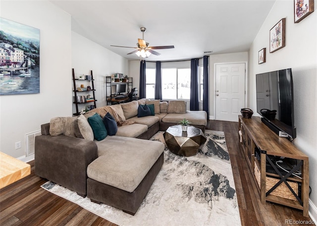 living room with ceiling fan and dark hardwood / wood-style floors