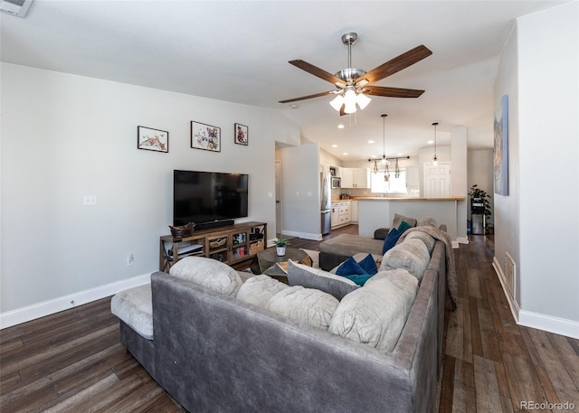 living room featuring lofted ceiling, dark hardwood / wood-style floors, and ceiling fan