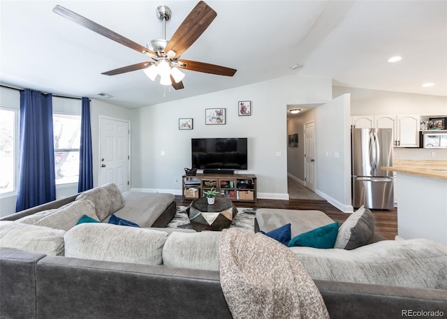 living room with ceiling fan, lofted ceiling, and dark hardwood / wood-style flooring