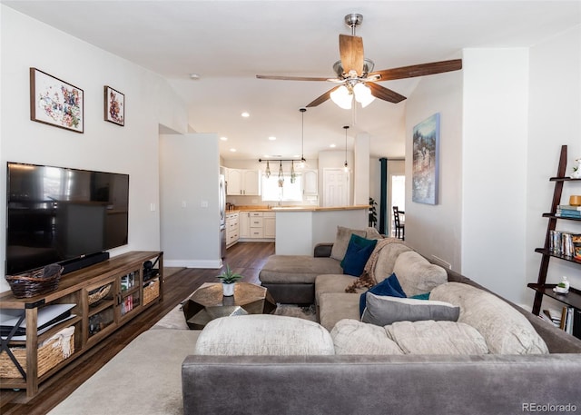 living room with ceiling fan, lofted ceiling, and dark hardwood / wood-style floors