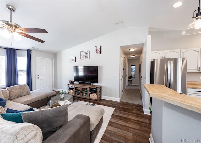 living room featuring dark wood-type flooring, ceiling fan, and vaulted ceiling