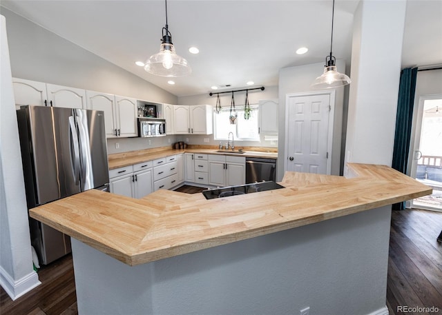 kitchen featuring sink, white cabinetry, black appliances, vaulted ceiling, and kitchen peninsula