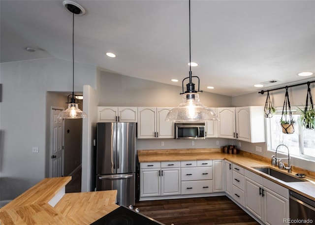 kitchen with stainless steel appliances, sink, and white cabinets