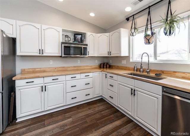 kitchen featuring stainless steel appliances, sink, white cabinets, and wooden counters