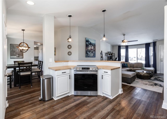 kitchen with white cabinetry, hanging light fixtures, stainless steel electric stove, and butcher block counters