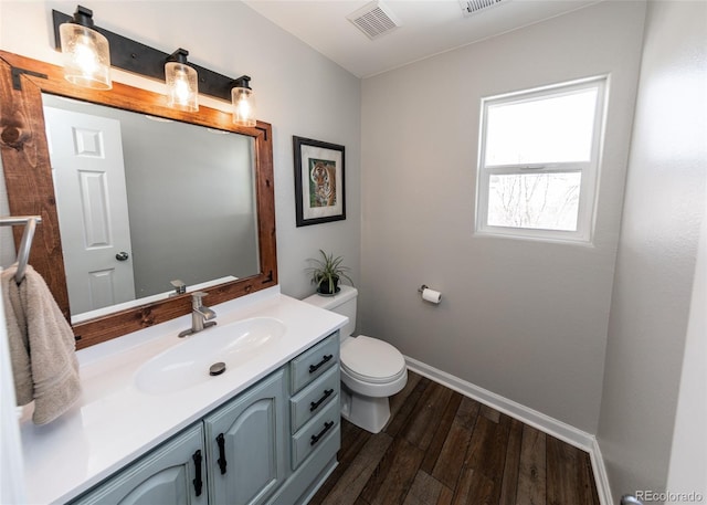 bathroom featuring hardwood / wood-style flooring, vanity, and toilet