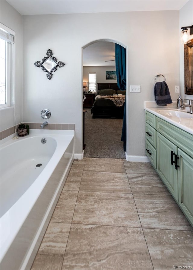 bathroom featuring vanity and a bath