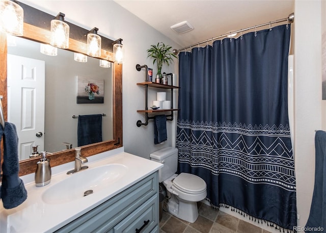 bathroom featuring vanity, toilet, and a shower with shower curtain