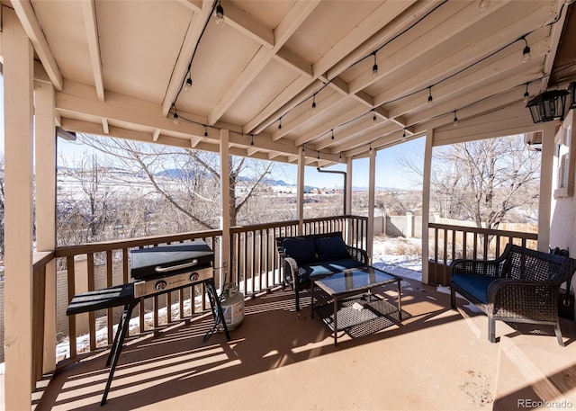 snow covered deck with an outdoor hangout area