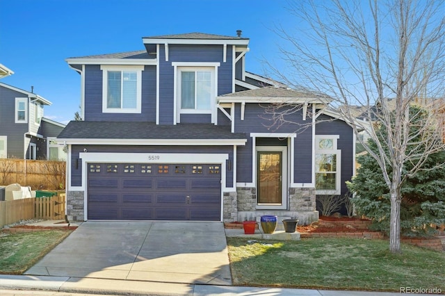 view of front of house featuring a garage and a front lawn