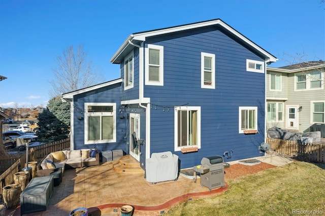 back of house with a lawn, outdoor lounge area, and a patio